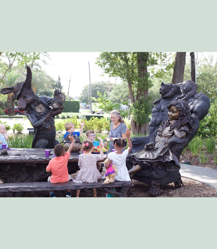 Texas sculptor Bridgette MOngeon with Alice in Wonderland in Evelyn's Park.