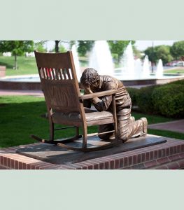 Bronze of praying man. Liturgical art.
